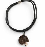 Short statement necklace with a ammonite fossil and pink pearl pendant on a white background