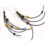 Pair of black and amber beaded earrings on a white background