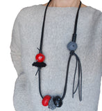  Chunky long Necklace with red and black beads on a gray background